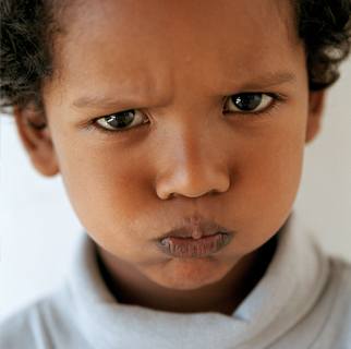 Close-up image a boy with a pouty face.