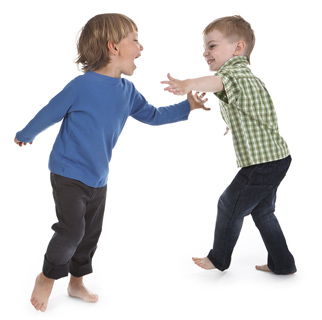 Two toddler boys playing together.